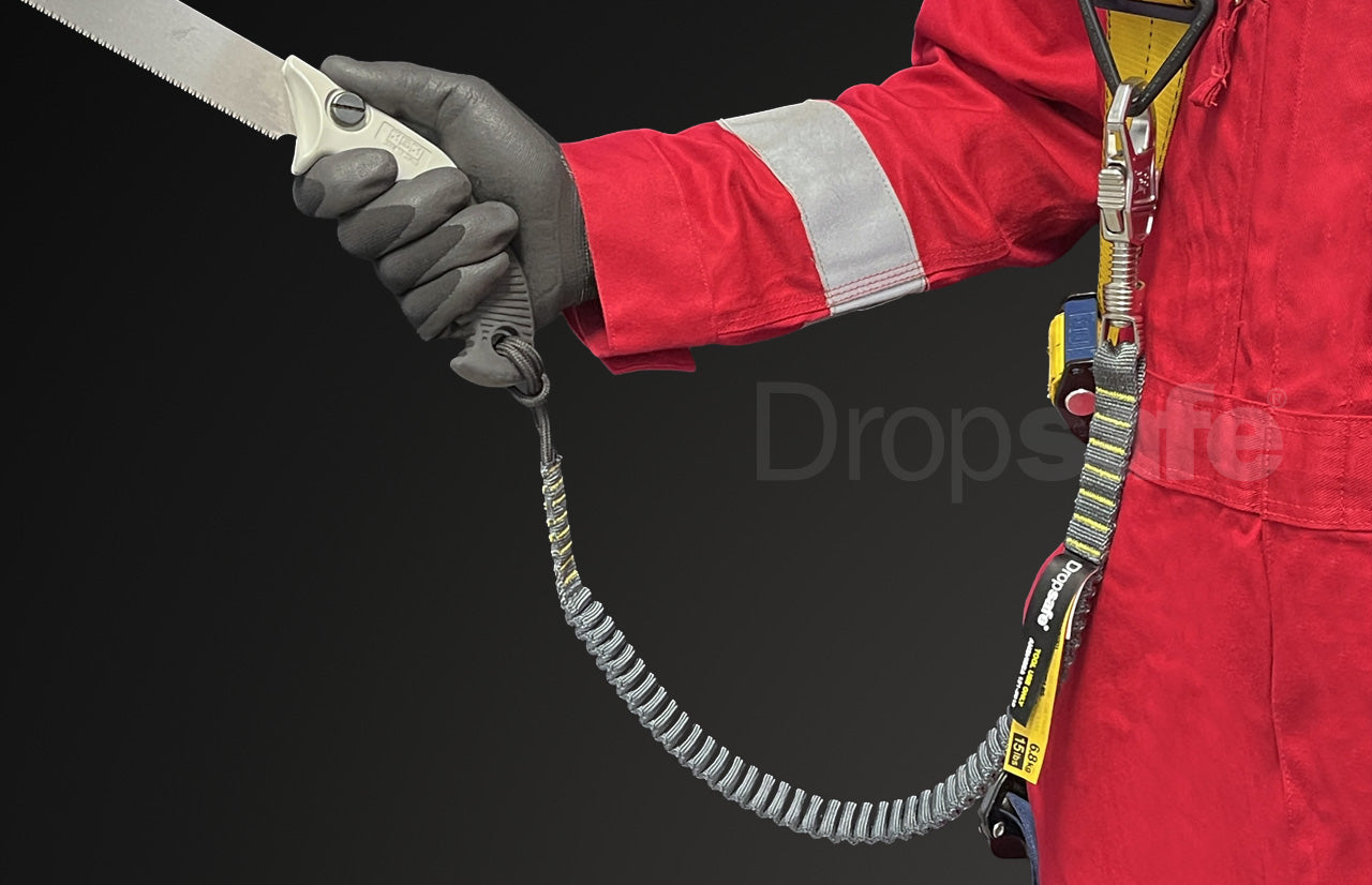 Silver and yellow-handled wire cutter with coiled safety tether on  bungee lanyard