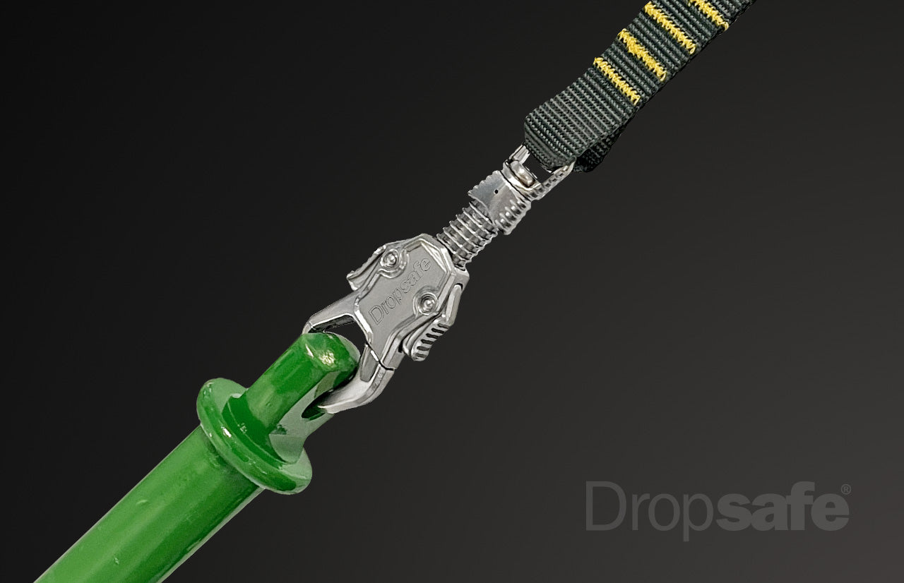 Green plastic handle with silver carabiner and black-yellow webbing loop lanyard