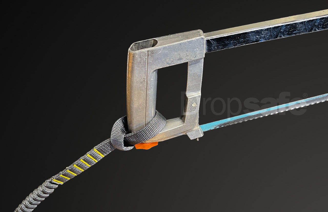 Gray and yellow striped webbing lanyard with orange buckle on hand saw handle