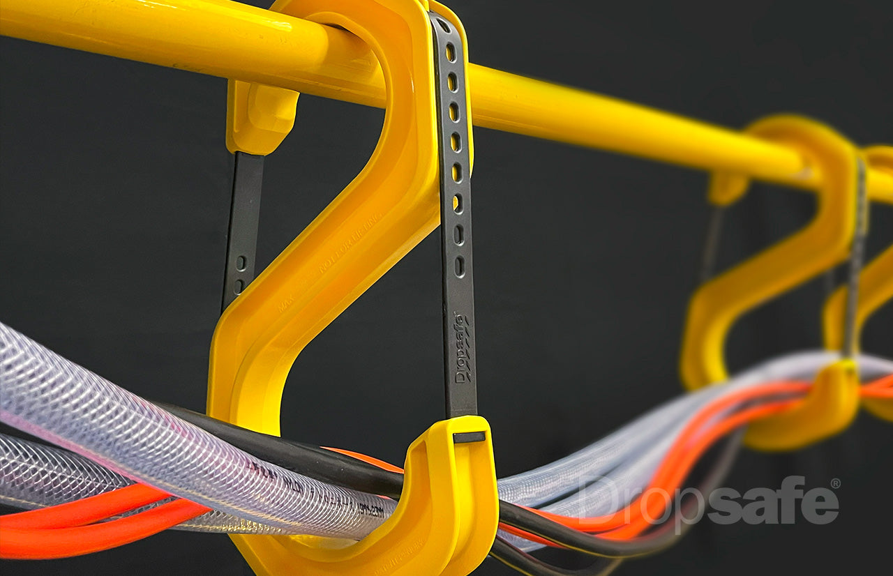 Yellow cable clips with black inserts holding colorful hoses, pack of 10