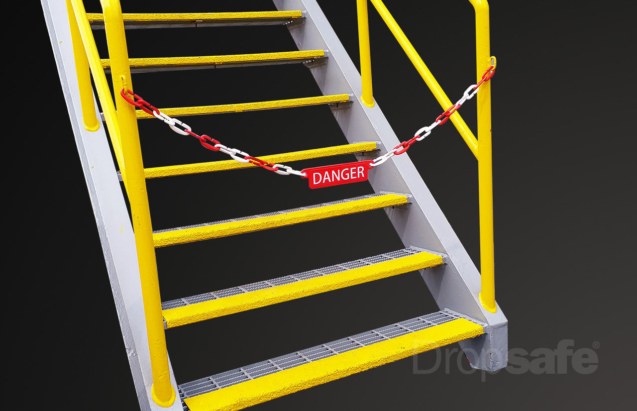 Yellow metal staircase with safety railings and red danger sign on chain for Dropsafe Accessories