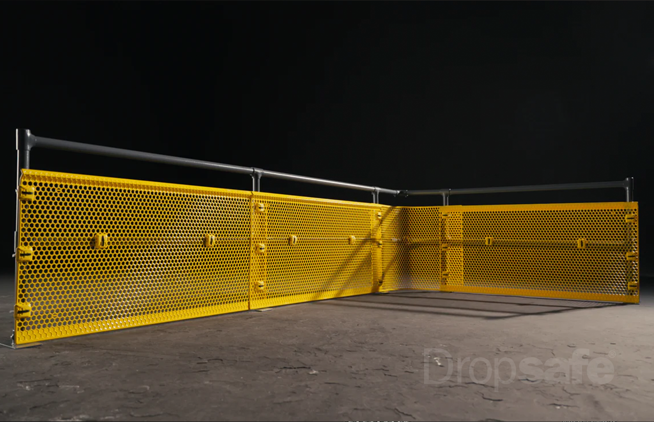 Yellow perforated metal safety barrier with gray rail top, Dropsafe