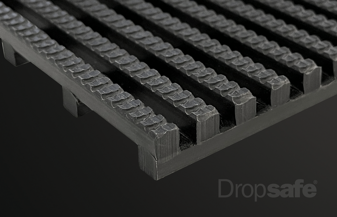 Black textured rubber Dropsafe Matting with raised interlocking ridges for grip and drainage