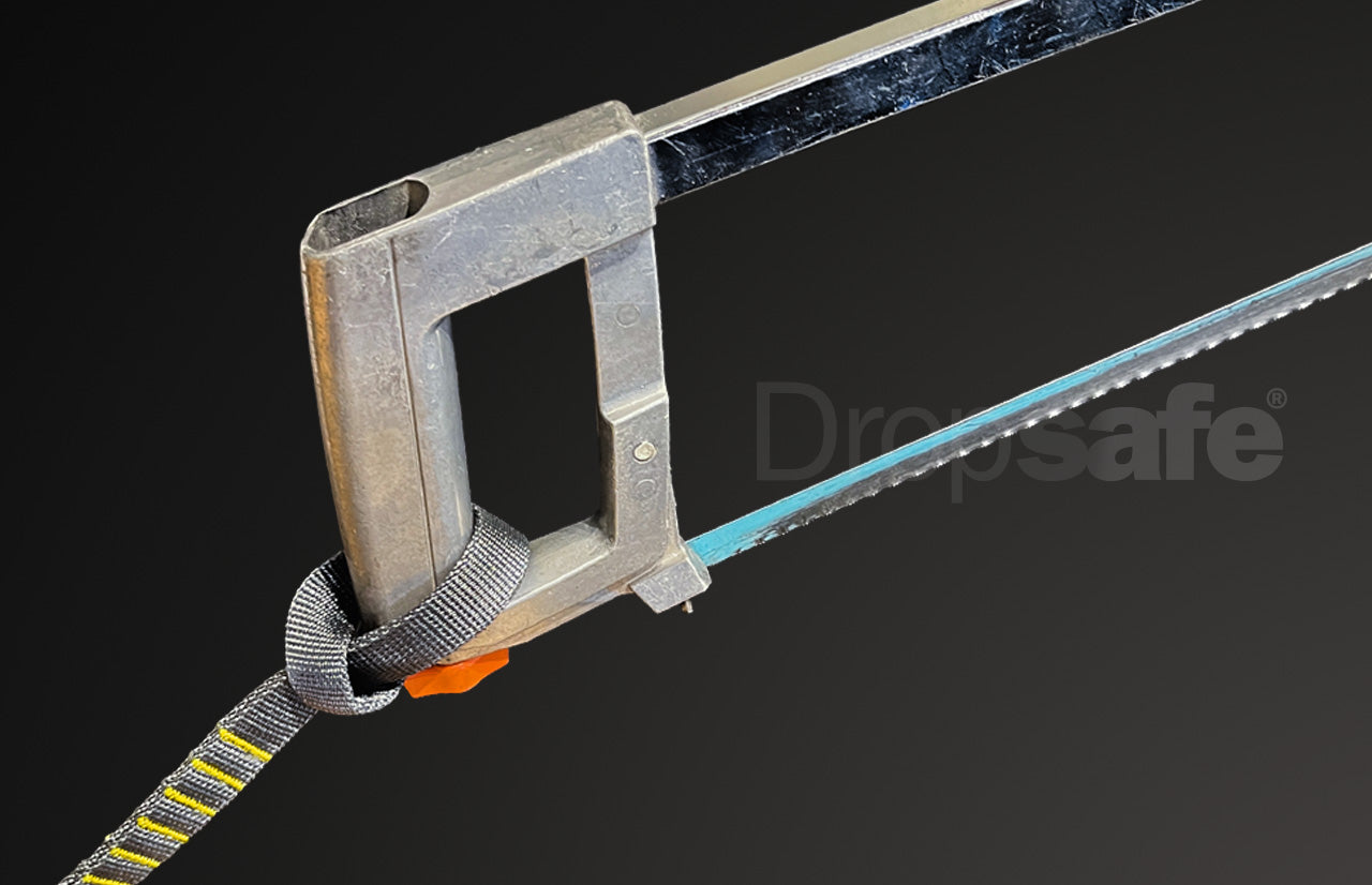 Gray and yellow striped webbing lanyard with orange buckle on hand saw handle