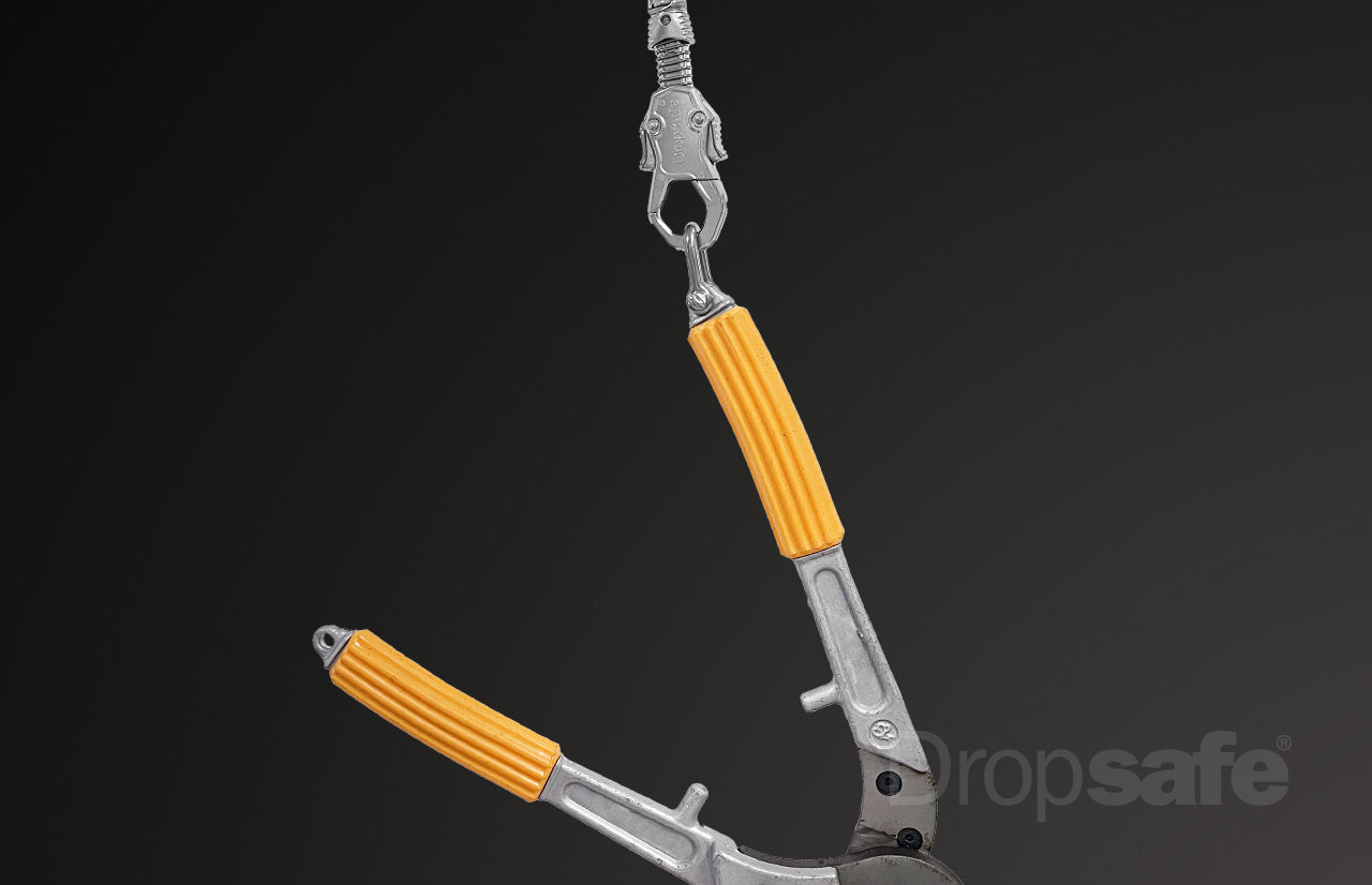 Silver wire tool lanyard with orange ribbed handles and Trisafe carabiner